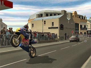 Screenshot from Suzuki TT Superbikes: Real Road Racing, featuring a motorcycle doing a wheelie on a city street.