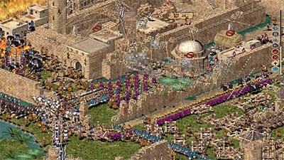 A screenshot of Stronghold: Crusader Extreme, depicting many units engaged in battle in a medieval city.