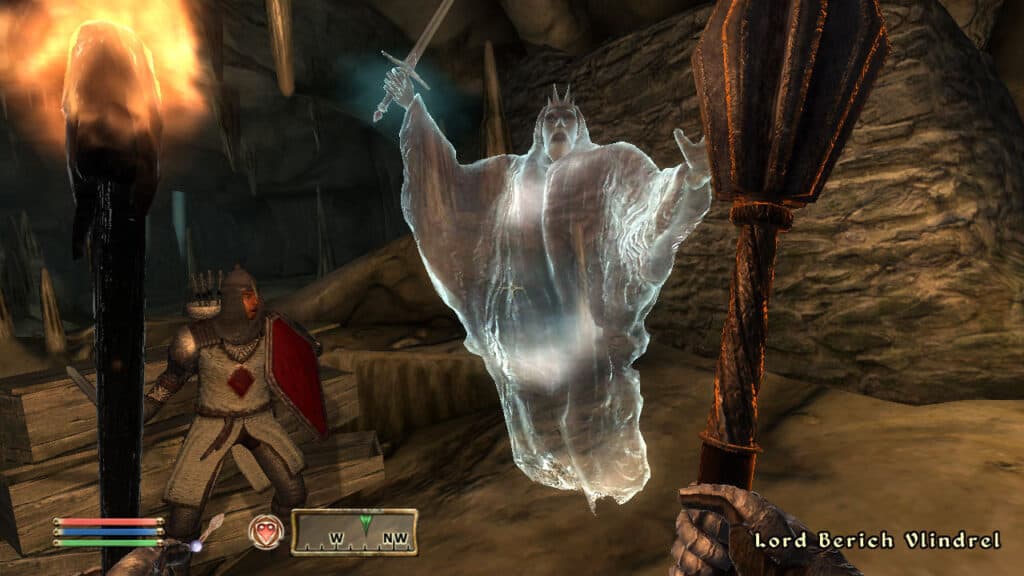 A ghost in the game Oblivion while the main character holds a torch and mace.