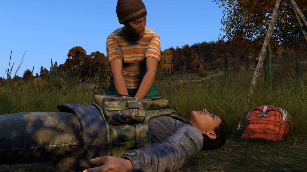 A DayZ survivor performs CPR on a downed teammate.