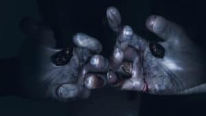 Ghost hands reach around to end a player's life in Phasmophobia.