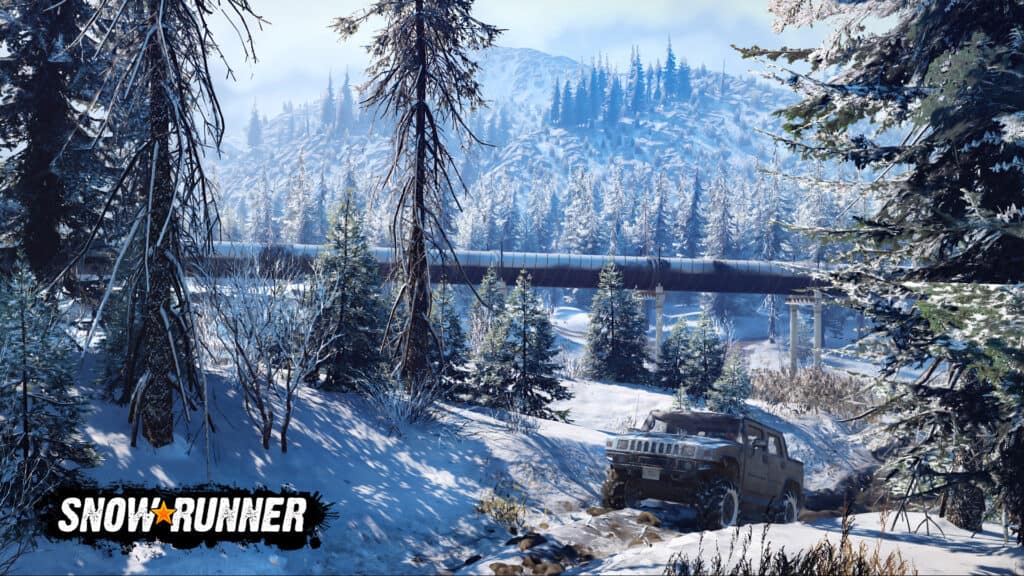 A screenshot from the game SnowRunner. A light blue truck drives through a forest of pine trees in the snow and mud. In the background is a large pipeline.