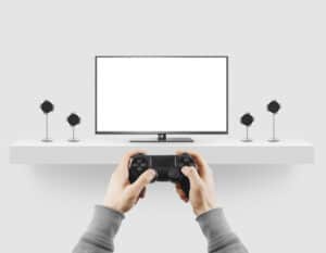 Man hold gamepad in hands in front of blank tv screen mock up playing game. Clear monitor mockup with gamer first person. Video gaiming console screen display. Gamer play game pad on tv screen.
