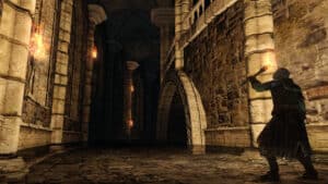 A player peers down a darkened hallway in Dark Souls 2.